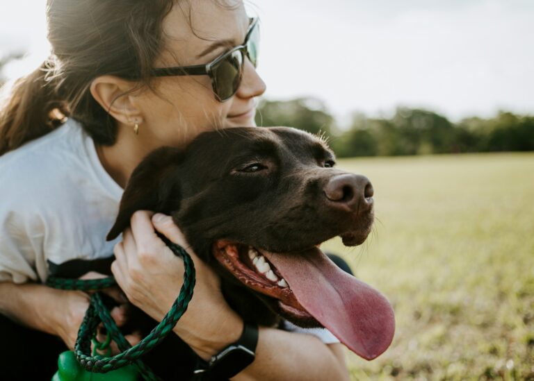 Person embracing a dog